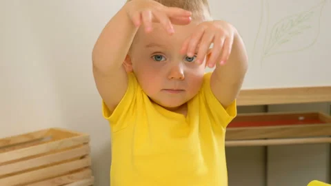 A 2-year-old preschool kid  making christmas tree from modeling clay (compound) 動画素材 99525154
