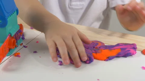 A 2-year-old preschool kid playing with modeling clay (compound) Stockbeeldmateriaal 104526720