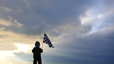 2 years old boy carry &amp; lift  the flag silhouette with sky background Stock Footage 100717391