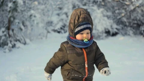 2 years old boy running slow motion in snow winter forest Stock Footage 101441465