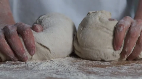 2 yeast balls being rolled into flour Stock Footage 89355736