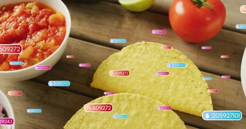 2 yellow corn taco shells sitting on wood table, showing salsa, tomato-lime, 库存照片