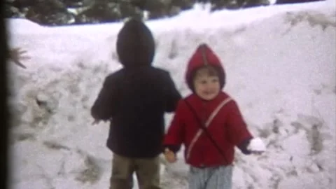 2 young boys touching snow for first time Stock Footage 194522044