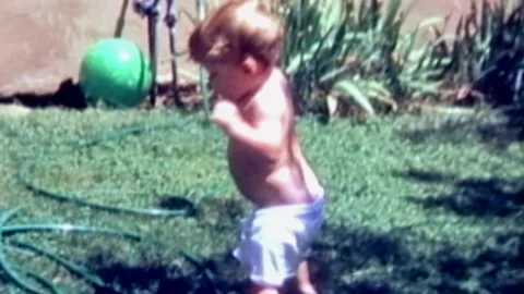 2 young brothers having fun in wader pool Stock Footage 194521520
