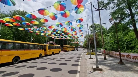 20-7-24; Rainbow colored umbrella hanging on the streets of Jhansi in the day Stock Footage 281470881