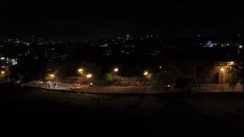 20-7-24; Vehicles navigating on the road with a distant city view in Jhansi. Stock Footage 281471257