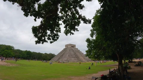 20 March 2024, Chichen Itza, Mexico: crowd walking around Kukulkan pyramid in Stock Footage 339025821