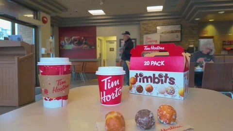 20-pack Timbits box on a table in a Tim Hortons fast-food restaurant Stock Footage 294951350