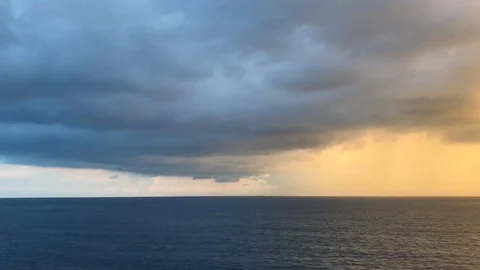 20-second video blue cloudy sky pan to golden sunset sky ocean horizon Stock Footage 96518524