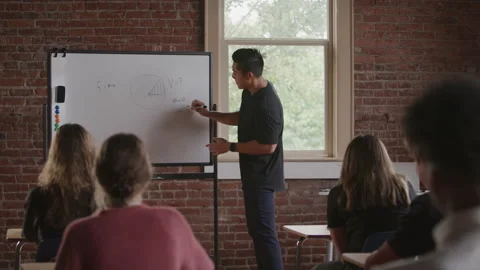 20 Something Middle School Math Teacher Uses Whiteboard to Explain Math Problem Stock Footage 208796271