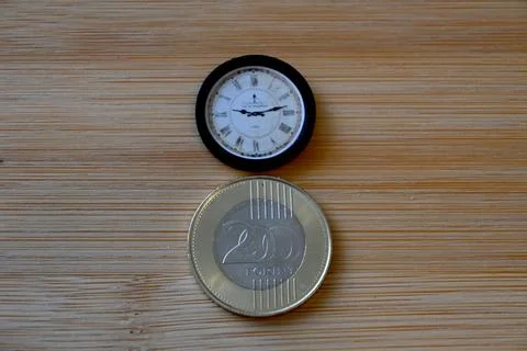 200 forint coin on table with small clock Photos
