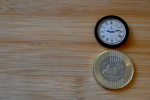 200 forint coin on table with small clock Photos