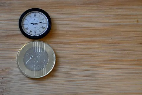 200 forint coin on table with small clock Fotos Stock