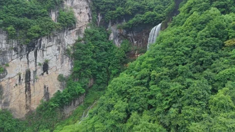 A 200-meter waterfall with perfect shape in the mountains Stock Footage 311736515