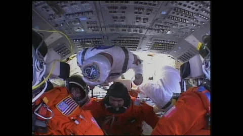 2000s: People help secure astronauts into seats onboard Space Shuttle before Stock Footage 145168742