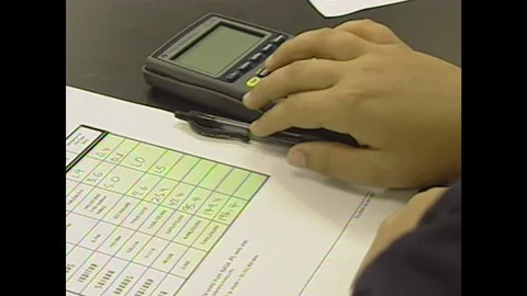 2000s: UNITED STATES: scale on chart. Students calculate measurements on paper. 動画素材 106414804