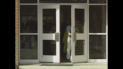 2000s: UNITED STATES: students open school doors. Students with toilet rolls in Stock Footage 106414903