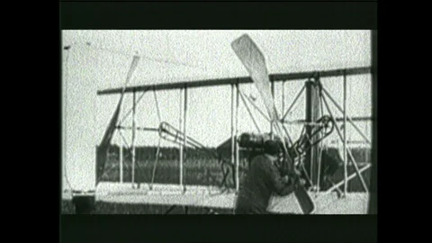 2000s: Wright Brothers test aircraft. Man talks and gestures. Boy talks. Stock Footage 129277733