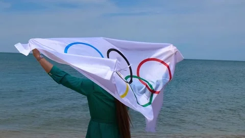 20.05.2021. Sochi. Summer Olympic Games in Tokyo. Girl with a flag on the beach Stock Footage 154903374