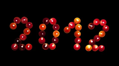 2012 made ​​of colored candles on a black background, timelapse Video stock 8848938