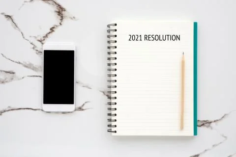 20121 resolution on blank notebook paper, smart phone with blank screen on wh Stock Photos