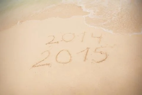 2014 and 2015 write on white sand Stock Photos