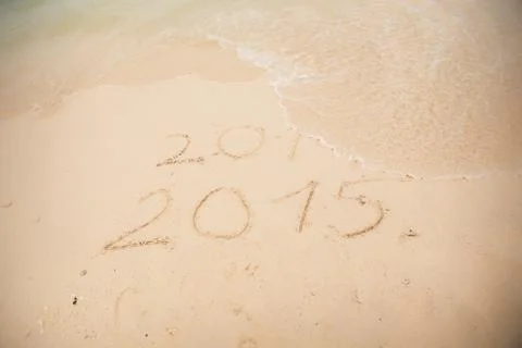 2014 and 2015 write on white sand Stock Photos
