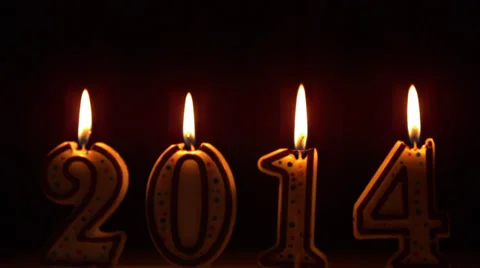 2014 candles flickering at night in slow motion Stock Footage 34703396