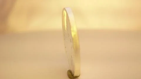 2014:.Coin On Rotating Table Spinning In Circle Stock Photos