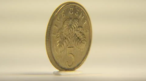 2014:View Of Five Cent Coin Rotating Around Vertical Axis On White Surface 스톡 사진