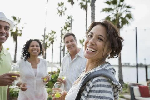 Portrait of smiling friends enjoying drinks on patio at resort, Resort Friends xkwx caucasian, ethnicity, looking, away, smiling, standing, head, and, shoulders, multi-ethnic, enjoyment, friendship, holding, four, people, togetherness, couple, outdoors, casual, clothing, bonding, happiness, beverage, african, american, wineglass, baby, boomer, 55-59, years, 40-44, 45-49, heterosexual, drink, refreshment, day, focus, on, foreground, leisure, activity, lifestyles, waist, up, weekend, activities, mature, adult, men, women, beautiful, food, vacations, alcohol, mixed, race, person, series, san, diego, california, united, states, hispanic, latin, tourist, resort, grape, palm, tree