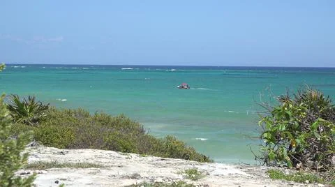 2015:TULUM MEXICO.Red Object Floating In Blue-Green Ocean Water On Sunny Day 스톡 사진