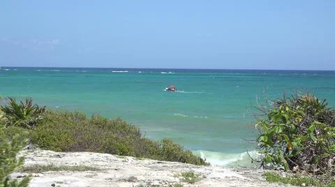 2015:TULUM MEXICO.Red Object Floating In Blue-Green Ocean Water On Sunny Day 스톡 사진