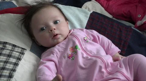2015:WESTMINSTER COLORADO.Baby On Patchwork Quilt Looking At Camera Fotos de archivo