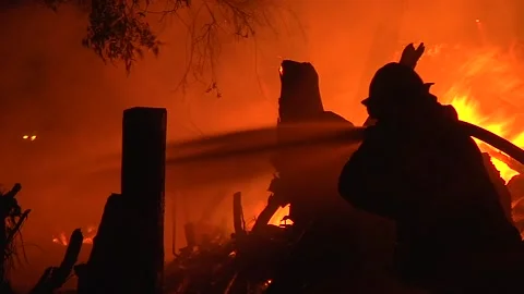 2017 - a firefighter fights a huge hillside blaze during the Thomas Fire in Stock Footage 157763712
