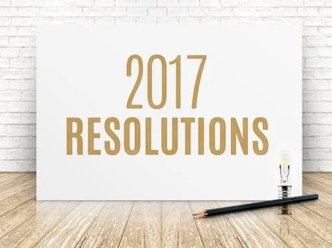 2017 resolutions text on white paper poster with black pencil and lightbulb o Stock Photos