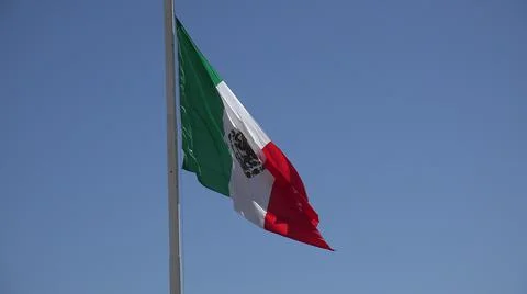 2017:LOS CABOS MEXICO.The Flag Of Mexico Flapping In The Wind Stock Photos