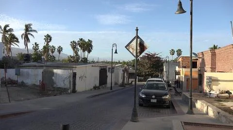 2017:LOS CABOS MEXICO.Cars Are Parallel Parked On Cobblestone Street Flanked By Fotos Stock