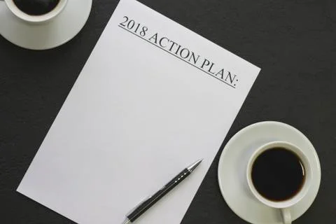 2018 action plan paper with white coffee cups and a black pen Stock Photos