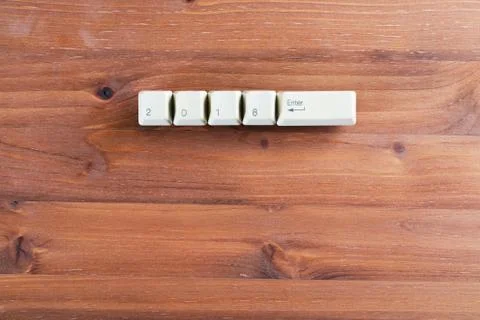 2018 enter on computer keyboard keys on a wooden background. New year 2018 card Foto stock
