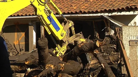 2018 - fire crews inspect damage from the mudslides in Montecito, California Stock Footage 92170450