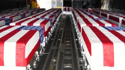 2018 - flag draped coffins of dead U.S. soldiers being returned home in a C-130 Stock Footage 100893994