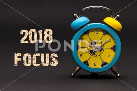 2018 focus written with alarm clock on black paper background Stock Illustration