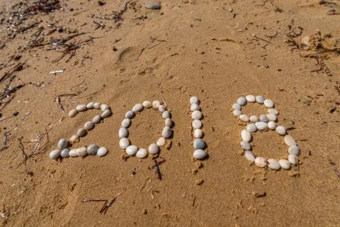 2018 New Year text on sand Stock Photos