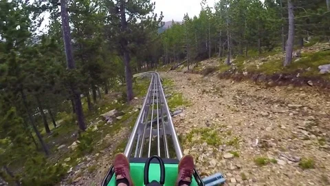2018 - POV of a rider on a sled rollercoaster track on a hillside in Andorra in Stock Footage 113688077