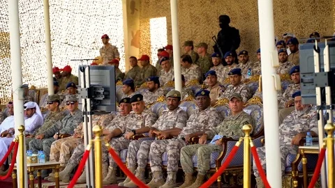 2018 - Qatar Armed Forces demonstrate cargo parachutes in front of an audience Stock Footage 100598704