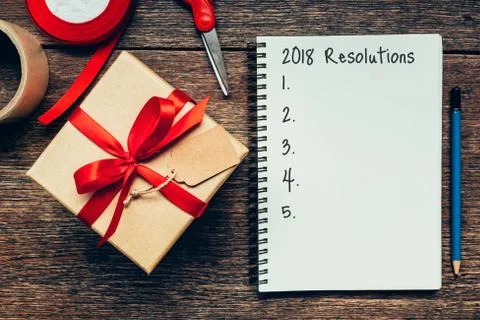 2018 Resolutions text on notebook paper with gift box. Stock Photos