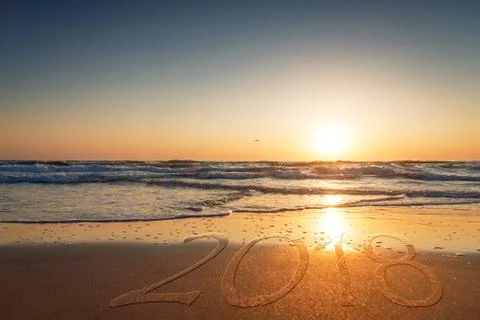 2018 written on the sand of a beach. Stock Photos