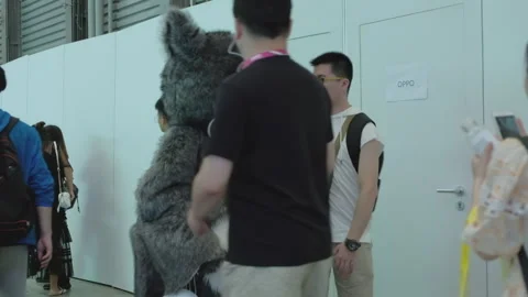 2019 Aug 04, Shanghai. Attendees interact with giant one-eyed monster fursuit Stock Footage 345906406