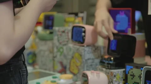 2019 Aug 04, Shanghai. Customers examine retro pixel art Bluetooth speakers Stock Footage 345909366